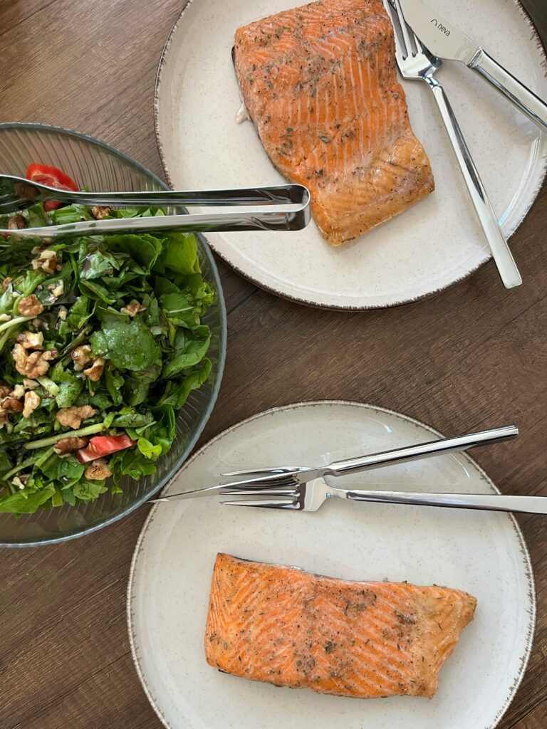 pexels-photo-32981281-32981281 Healthy homemade dinner featuring grilled salmon and fresh walnut salad.